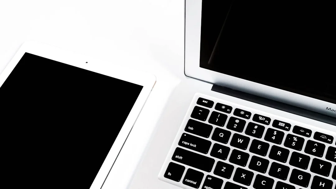 A miniature shopping cart placed on a laptop keyboard symbolizing online shopping and e-commerce.